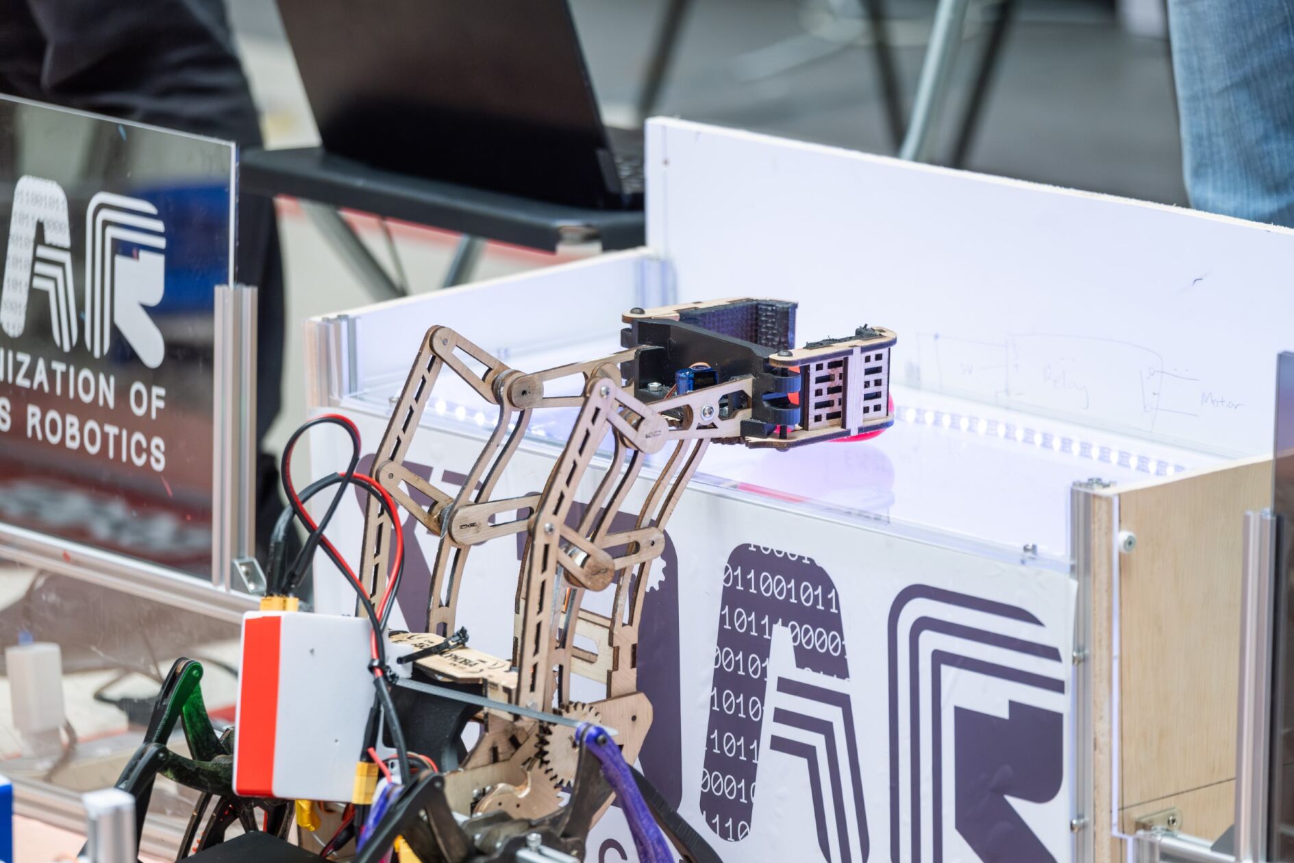 The robot putting a rock on a podium